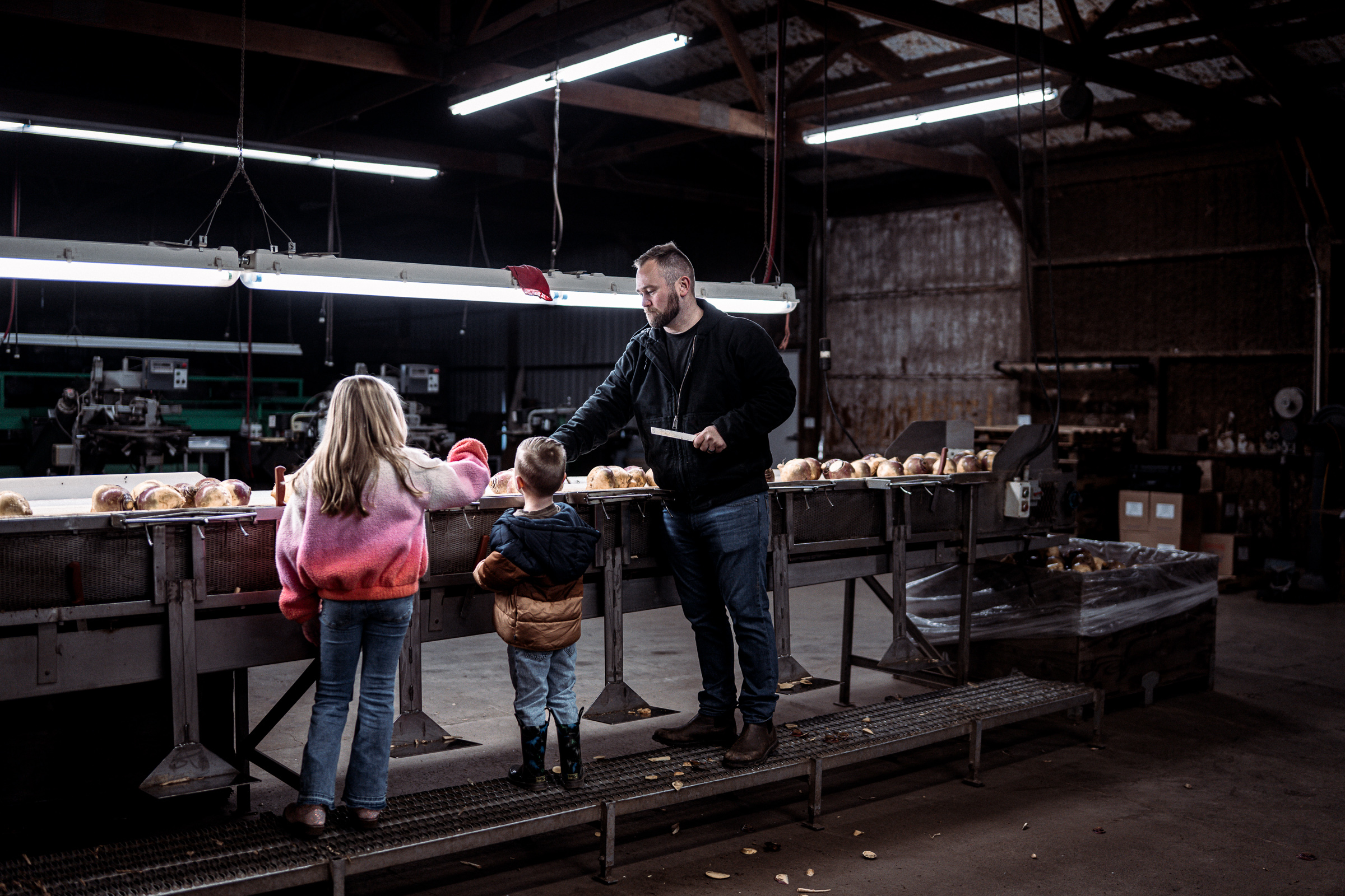 blue collar farmer working with children